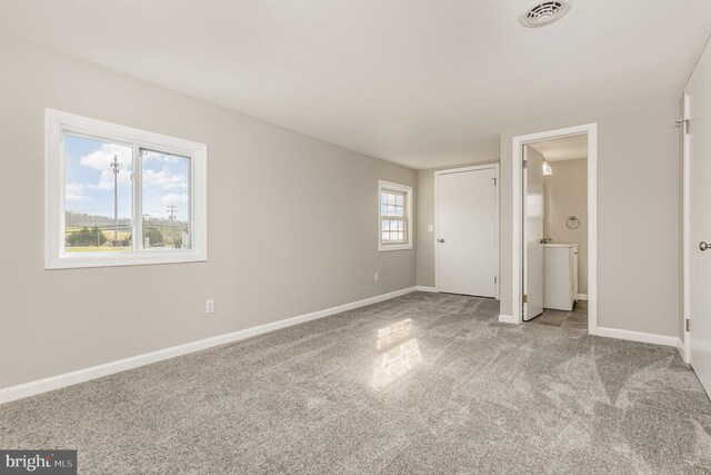 unfurnished bedroom with multiple windows and light colored carpet