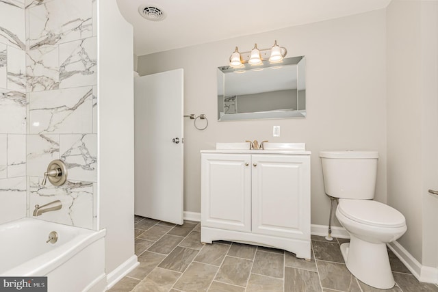 full bathroom with tiled shower / bath combo, toilet, and vanity