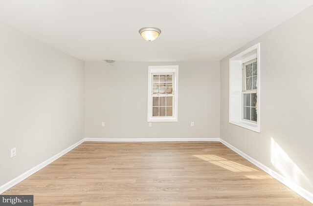 empty room with light hardwood / wood-style flooring