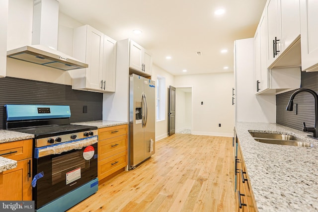 kitchen featuring stainless steel fridge, sink, exhaust hood, black range, and white cabinets