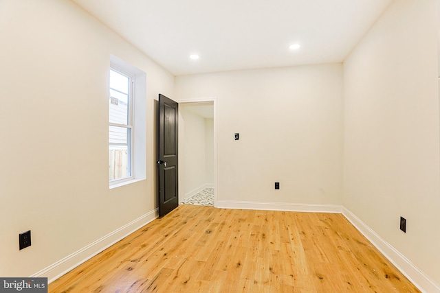 spare room with hardwood / wood-style flooring