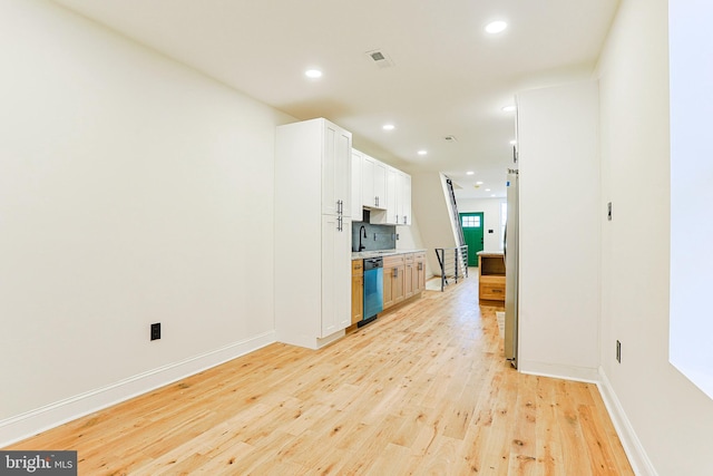 kitchen with white cabinetry, light hardwood / wood-style flooring, stainless steel appliances, and sink