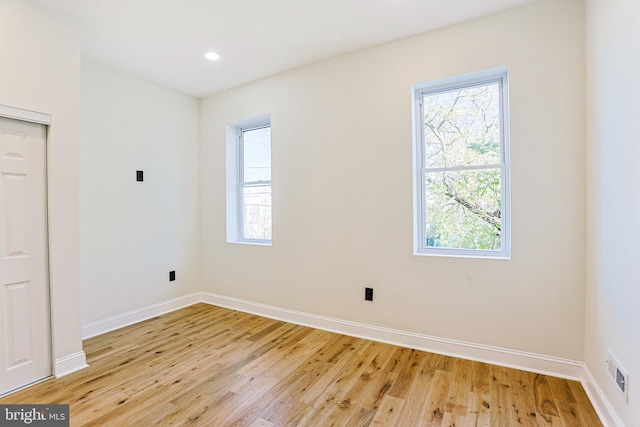 spare room featuring light wood-type flooring