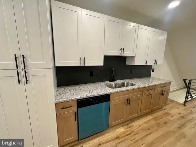 kitchen featuring sink, stainless steel dishwasher, light stone countertops, light wood-type flooring, and white cabinetry