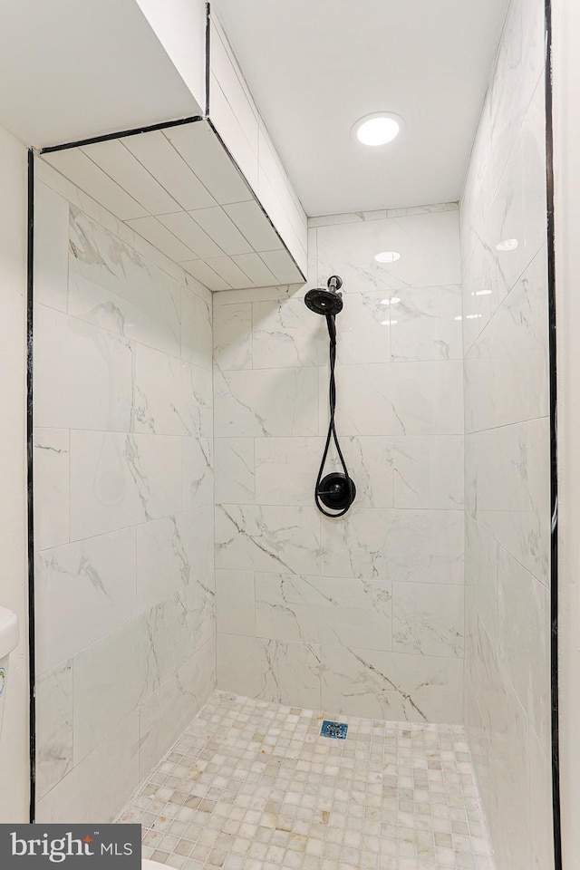 bathroom with tiled shower