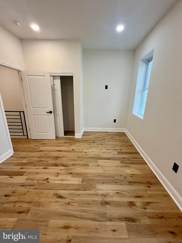 laundry area with light hardwood / wood-style flooring