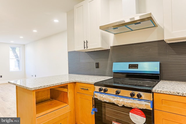 kitchen featuring white cabinetry, electric stove, and extractor fan