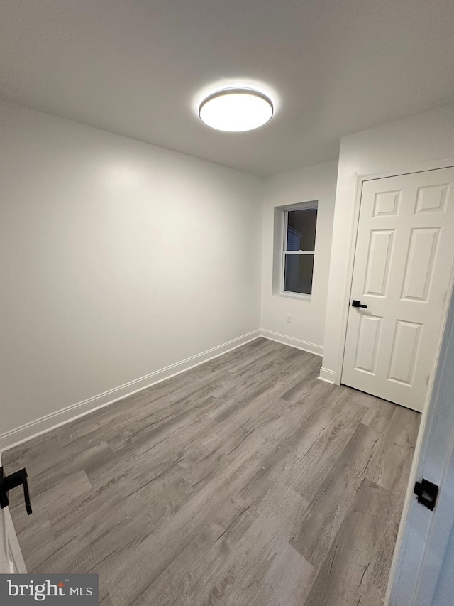 unfurnished room with light wood-type flooring