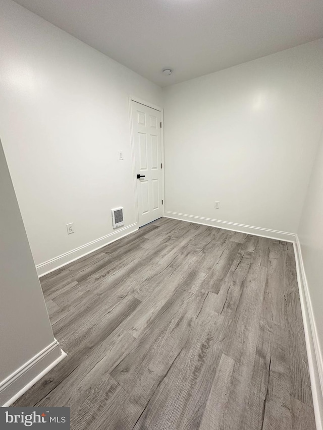 unfurnished room featuring hardwood / wood-style floors