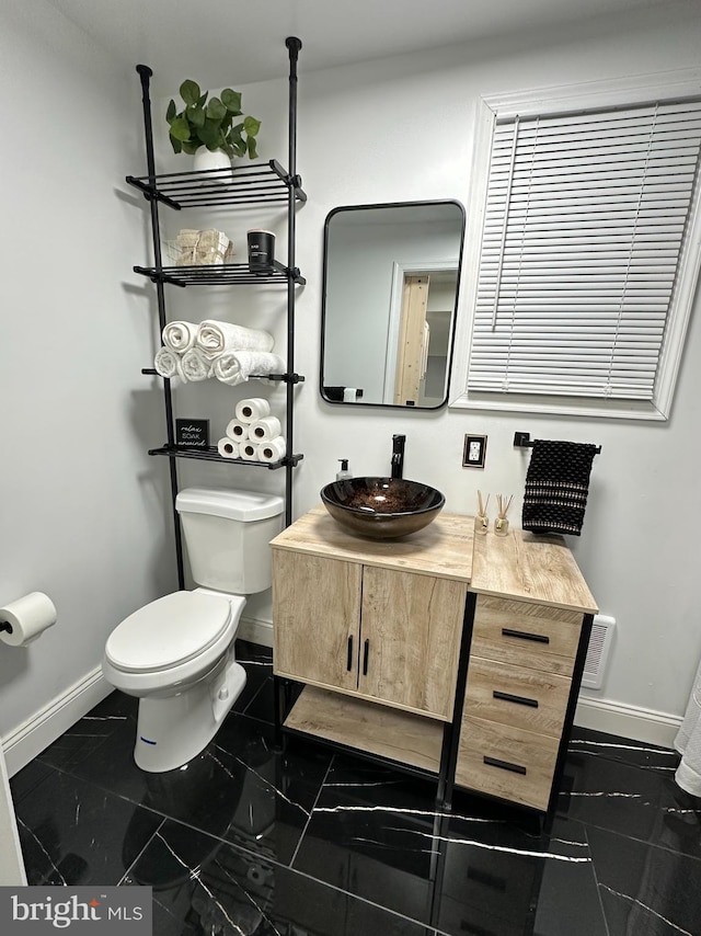 bathroom with vanity and toilet