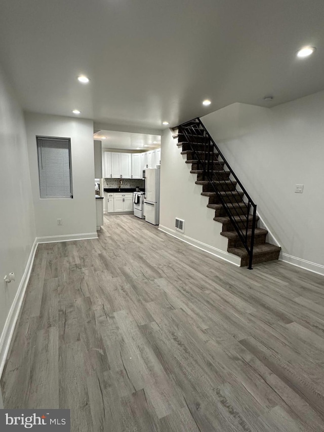 interior space featuring white fridge and light wood-type flooring