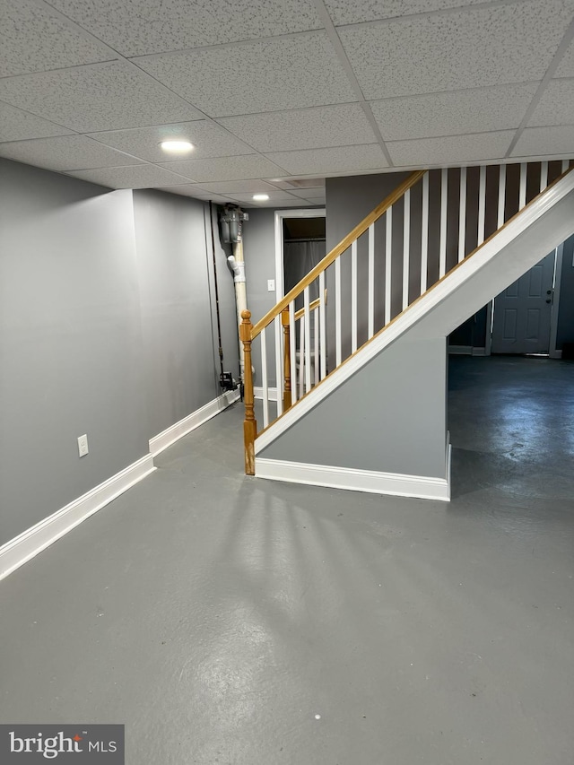 basement featuring a paneled ceiling