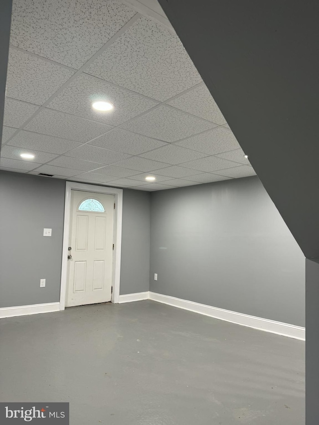 entryway featuring concrete floors and a drop ceiling