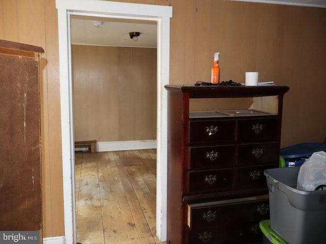 interior space featuring wooden walls and light hardwood / wood-style flooring