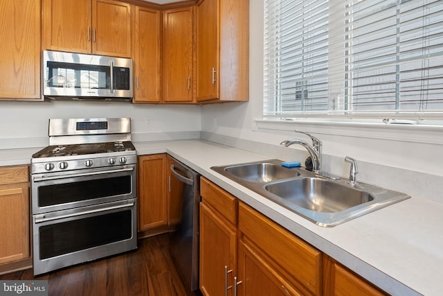 kitchen featuring dark hardwood / wood-style floors, a healthy amount of sunlight, sink, and appliances with stainless steel finishes