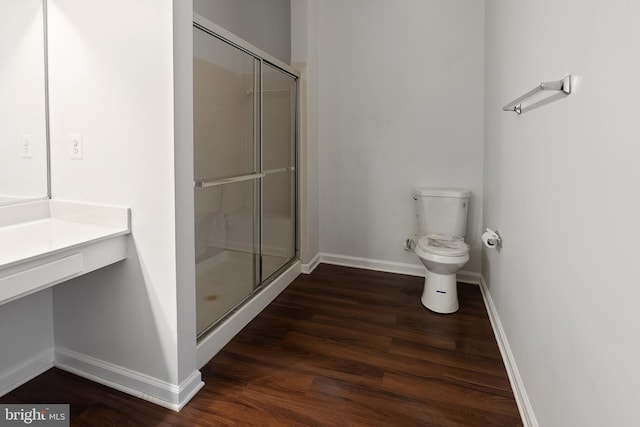 bathroom featuring wood-type flooring, toilet, and walk in shower