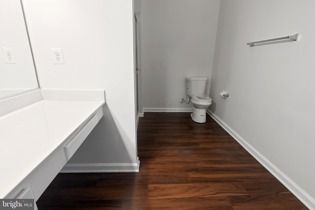 bathroom featuring hardwood / wood-style flooring and toilet