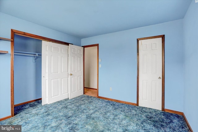 unfurnished bedroom with a closet and dark carpet