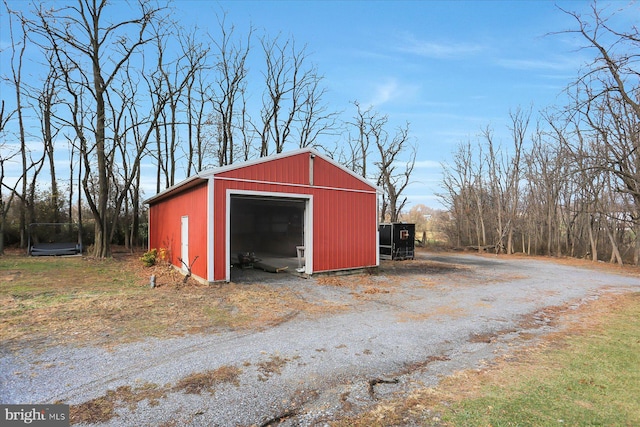 view of outbuilding with a trampoline and a garage