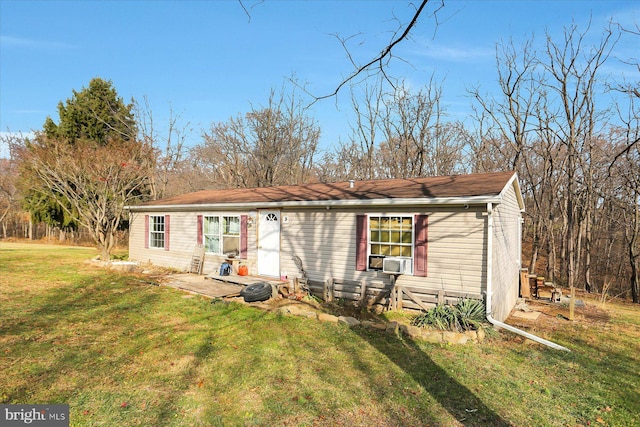 view of front of home with a front yard and cooling unit