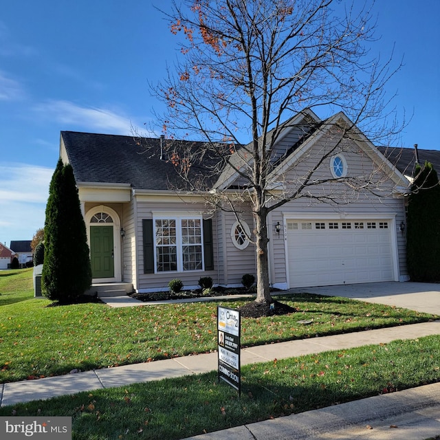 view of front of property with a garage and a front yard