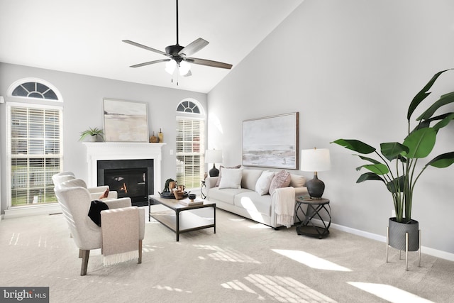 living room with light colored carpet, high vaulted ceiling, and ceiling fan