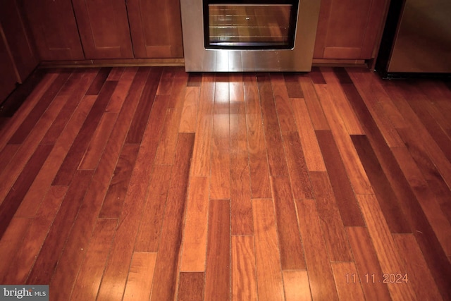 room details with dark hardwood / wood-style floors and stainless steel range