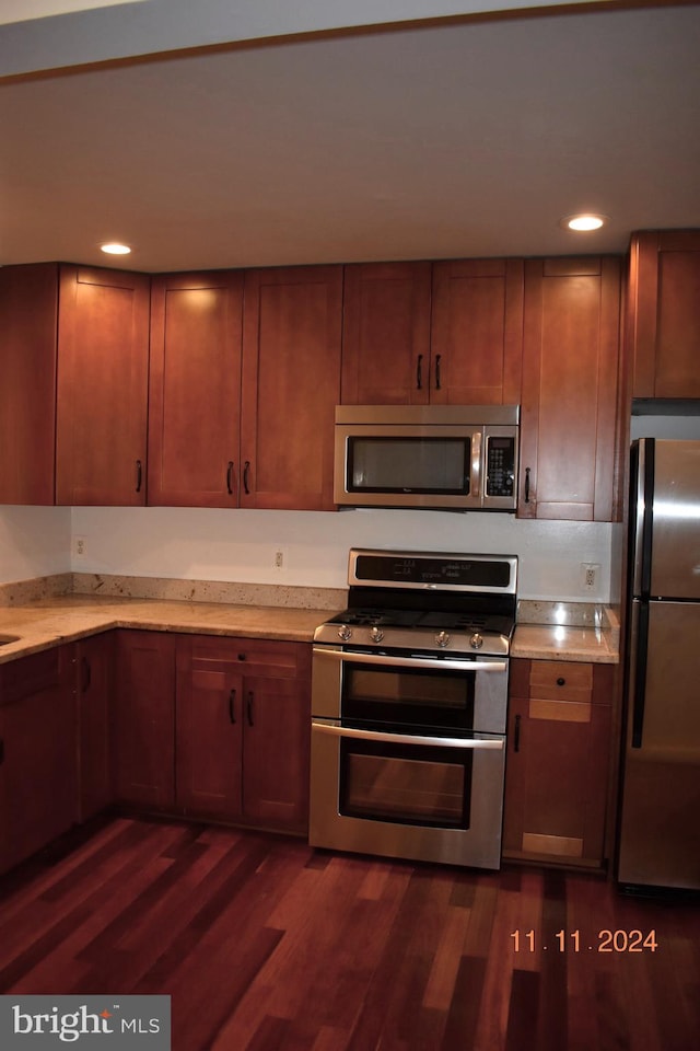 kitchen featuring dark hardwood / wood-style floors and stainless steel appliances