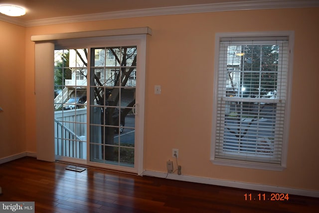 unfurnished dining area with dark hardwood / wood-style flooring and ornamental molding