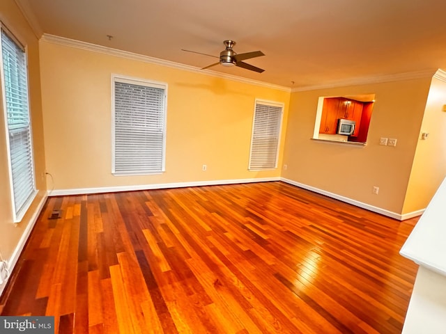 spare room featuring hardwood / wood-style flooring, ceiling fan, and ornamental molding