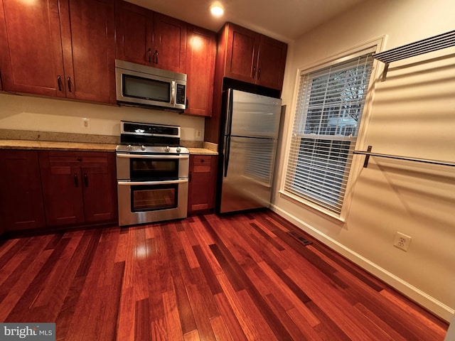 kitchen with dark wood-type flooring and stainless steel appliances