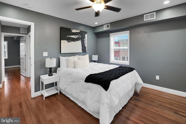 bedroom with ceiling fan and dark hardwood / wood-style floors