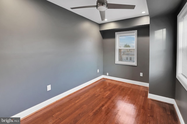 empty room with hardwood / wood-style flooring, a wealth of natural light, and ceiling fan