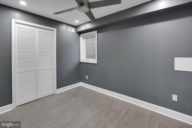 unfurnished bedroom featuring light wood-type flooring, a closet, and ceiling fan