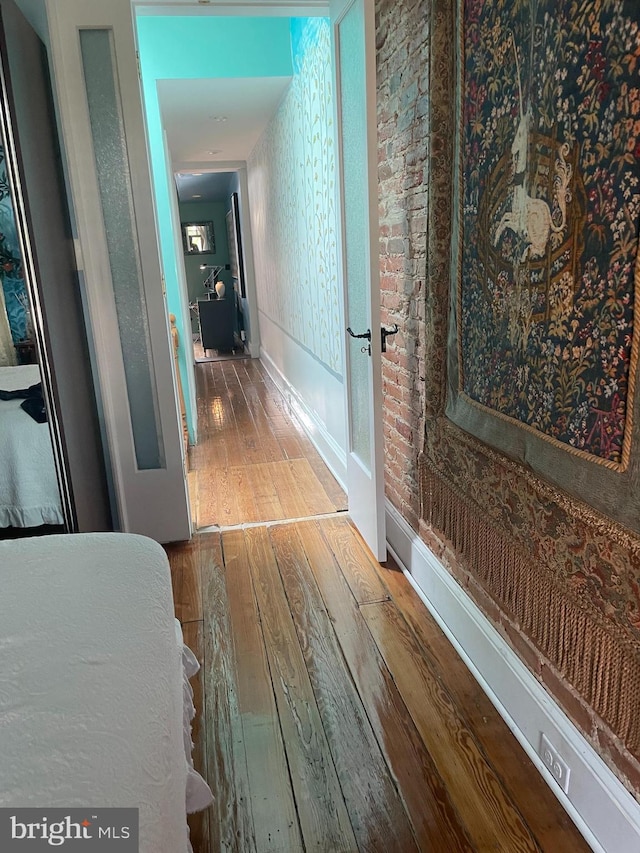 hallway with hardwood / wood-style flooring