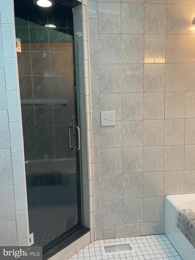 bathroom featuring a shower with shower door