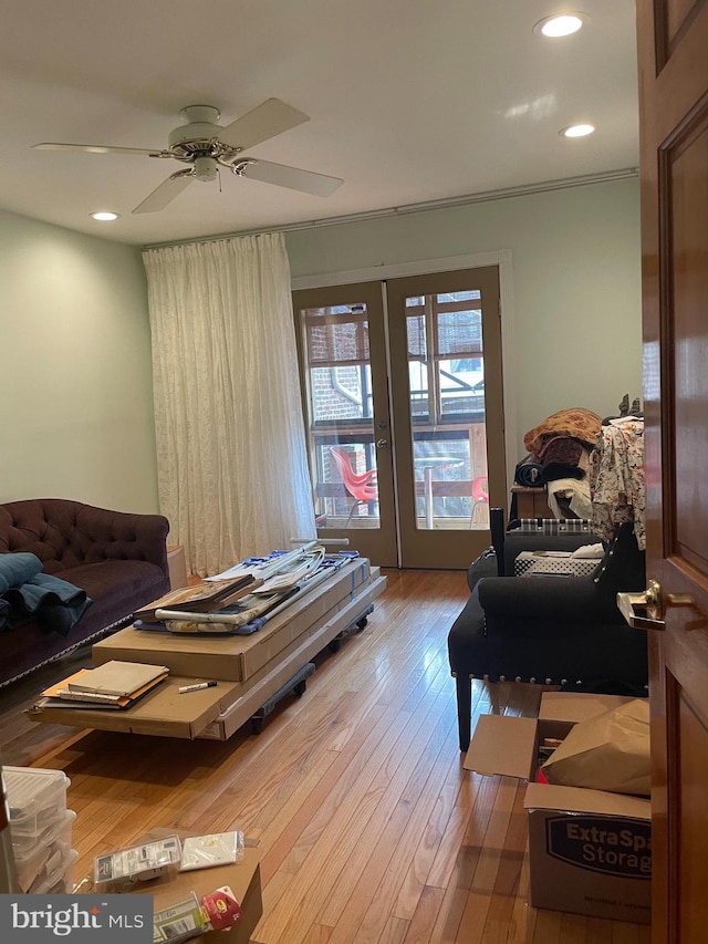 living room with hardwood / wood-style flooring, ceiling fan, ornamental molding, and french doors