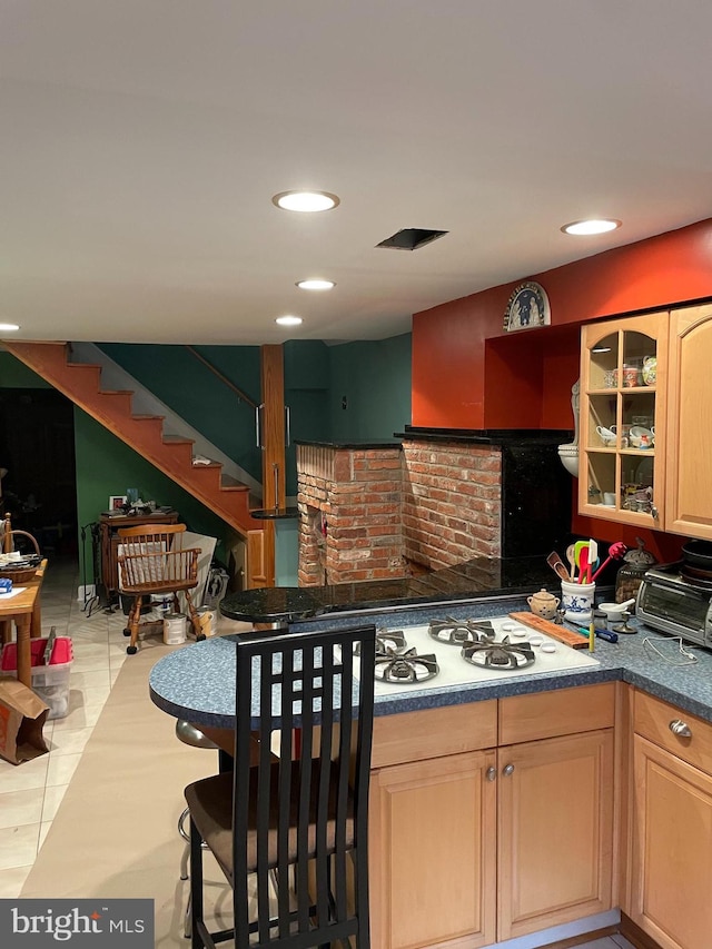 kitchen with light tile patterned flooring and light brown cabinetry