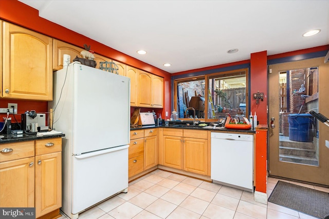 kitchen featuring light tile patterned flooring, white appliances, and sink