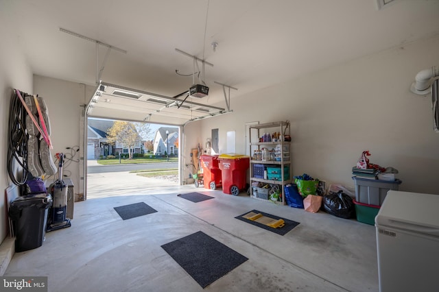 garage with a garage door opener and fridge