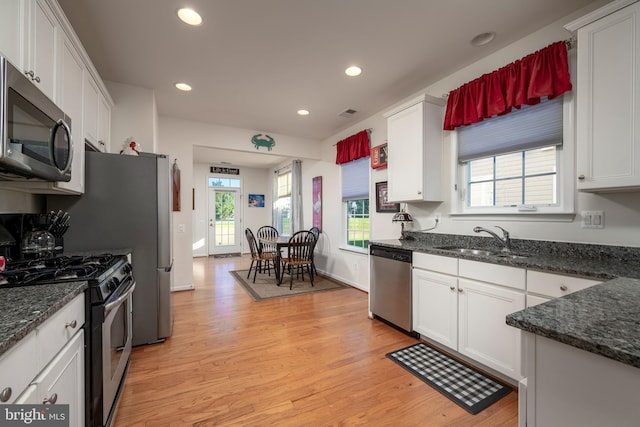 kitchen featuring light hardwood / wood-style flooring, stainless steel appliances, white cabinetry, and sink