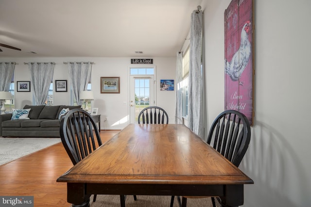 dining area with ceiling fan and light wood-type flooring