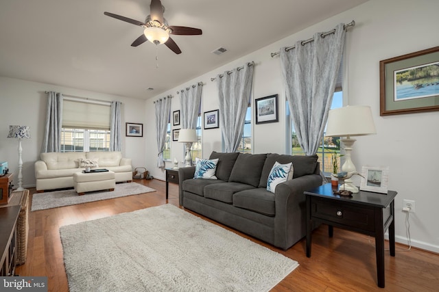 living room with hardwood / wood-style floors and ceiling fan