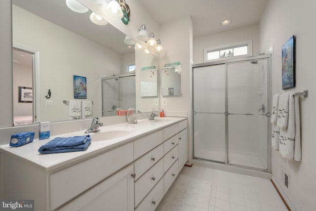 bathroom with tile patterned floors, vanity, and a shower with shower door