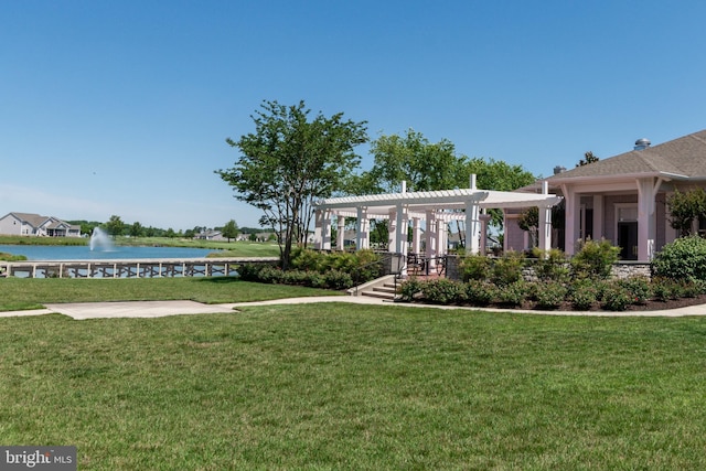 view of yard with a pergola and a water view