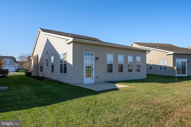 rear view of house featuring a patio area and a lawn