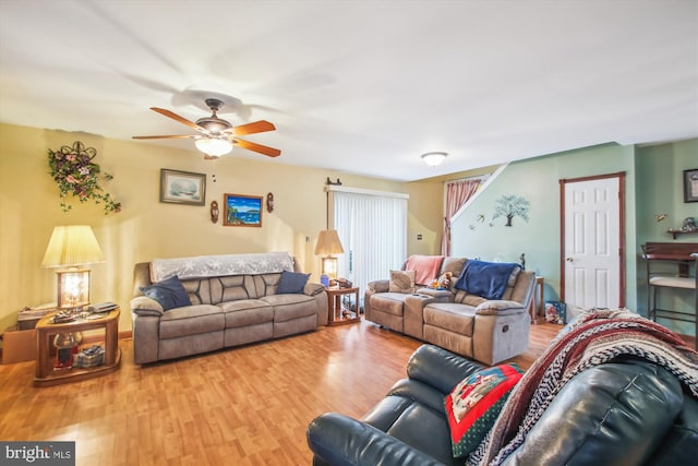 living room featuring ceiling fan and wood-type flooring