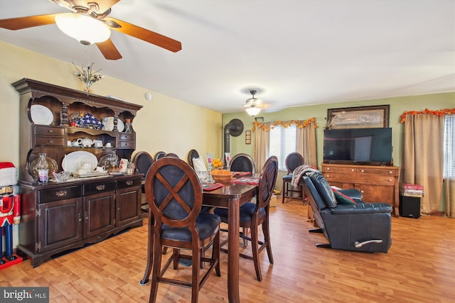 dining area with ceiling fan and light hardwood / wood-style flooring