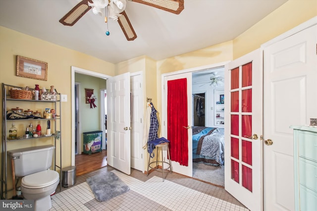 tiled bedroom featuring french doors, a closet, and ceiling fan