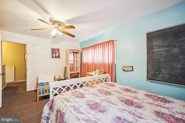 bedroom featuring ceiling fan and dark carpet